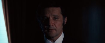 Movie still from “Dirty Harry” (1971), directed by Don Siegel – A person wearing a suit and tie; Close Up shot, Low angle