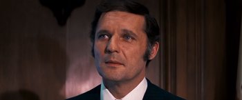 Movie still from “Dirty Harry” (1971), directed by Don Siegel – A man in a suit and tie looking to his left; Close Up shot, High angle