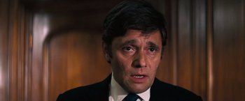 Movie still from “Dirty Harry” (1971), directed by Don Siegel – A person wearing a suit and tie; Close Up shot, High angle