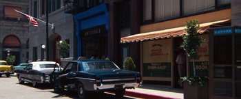 Movie still from “Dirty Harry” (1971), directed by Don Siegel – An old car parked on the side of the street; Wide shot, High angle