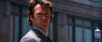 Movie still from “Dirty Harry” (1971), directed by Don Siegel – A person wearing a suit and tie; Close Up shot, Low angle