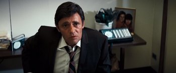 Movie still from “Dirty Harry” (1971), directed by Don Siegel – A person wearing a suit and tie; Close Up shot, Over the shoulder angle