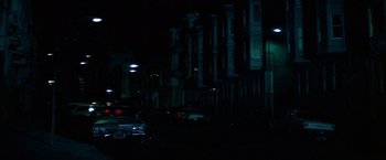 Movie still from “Dirty Harry” (1971), directed by Don Siegel – Cars parked on the side of the road at night; Extreme Wide shot, Low angle