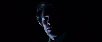 Movie still from “Dirty Harry” (1971), directed by Don Siegel – A person in a dark room; Close Up shot, Low angle