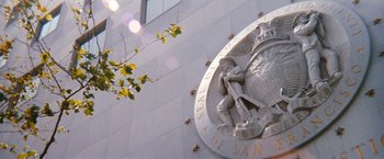 Movie still from “Dirty Harry” (1971), directed by Don Siegel – View of a statue on the side of a building; Extreme Wide shot, Low angle