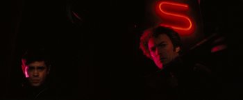 Movie still from “Dirty Harry” (1971), directed by Don Siegel – A man in a black jacket is in the dark; Close Up shot, Low angle