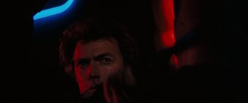 Movie still from “Dirty Harry” (1971), directed by Don Siegel – A person in a dark room; Close Up shot, Low angle