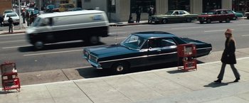 Movie still from “Dirty Harry” (1971), directed by Don Siegel – A car is driving down the street with a van in front of it; Wide shot, High angle