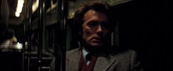 Movie still from “Dirty Harry” (1971), directed by Don Siegel – A person wearing a suit and tie; Close Up shot, Low angle