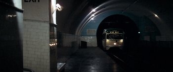 Movie still from “Dirty Harry” (1971), directed by Don Siegel – A train is coming down the tracks in a tunnel; Extreme Wide shot, High angle