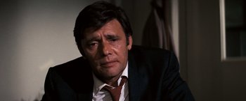 Movie still from “Dirty Harry” (1971), directed by Don Siegel – A person wearing a suit and tie; Close Up shot, High angle