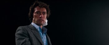 Movie still from “Dirty Harry” (1971), directed by Don Siegel – A person wearing a suit and tie; Close Up shot, Low angle