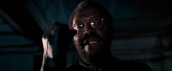 Movie still from “Dirty Harry” (1971), directed by Don Siegel – A person wearing glasses and a beard; Close Up shot, Low angle