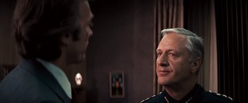 Movie still from “Dirty Harry” (1971), directed by Don Siegel – A man in a military uniform looking at another man in a suit; Close Up shot, Over the shoulder angle