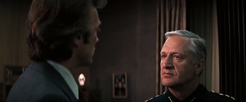 Movie still from “Dirty Harry” (1971), directed by Don Siegel – A man in a military uniform talking to another man in a suit; Close Up shot, Over the shoulder angle