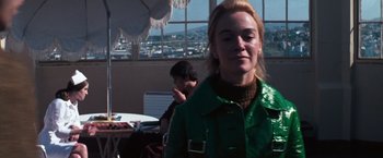 Movie still from “Dirty Harry” (1971), directed by Don Siegel – A woman wearing a green jacket standing in front of a window; Close Up shot, Low angle