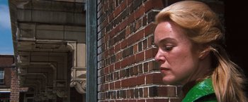 Movie still from “Dirty Harry” (1971), directed by Don Siegel – A woman leaning up against a brick wall with her eyes closed; Close Up shot, Low angle