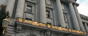 Movie still from “Dirty Harry” (1971), directed by Don Siegel – A man standing on the balcony of a building; Extreme Wide shot, Low angle