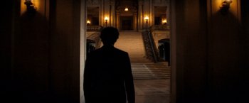 Movie still from “Dirty Harry” (1971), directed by Don Siegel – A man standing in front of a large staircase at night; Wide shot, Low angle