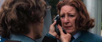 Movie still from “Dirty Harry” (1971), directed by Don Siegel – A woman is talking on a cell phone while looking in the mirror; Close Up shot, High angle