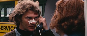 Movie still from “Dirty Harry” (1971), directed by Don Siegel – A man with bandages on his face talking on the phone; Close Up shot, Over the shoulder angle