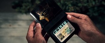 Movie still from “Dirty Harry” (1971), directed by Don Siegel – A person holding a police badge in their wallet; Extreme Close Up shot, High angle