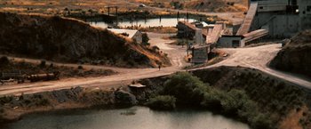 Movie still from “Dirty Harry” (1971), directed by Don Siegel – An aerial view of an industrial area near a river; Extreme Wide shot, High angle