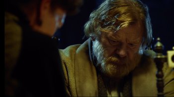 Movie still from “In the Heart of the Sea” (2015), directed by Ron Howard – An old man with a beard and a mustache is looking at a young woman; Close Up shot, Over the shoulder angle