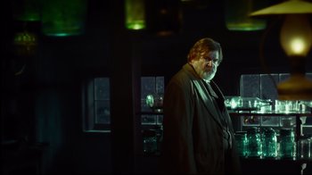 Movie still from “In the Heart of the Sea” (2015), directed by Ron Howard – An older man standing in a dark room; Medium shot, Over the shoulder angle