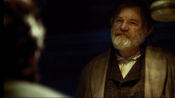Movie still from “In the Heart of the Sea” (2015), directed by Ron Howard – An older man with a beard and a mustache; Close Up shot, Over the shoulder angle