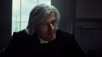 Movie still from “In the Heart of the Sea” (2015), directed by Ron Howard – An old man with a long gray hair and a white beard; Close Up shot, Over the shoulder angle