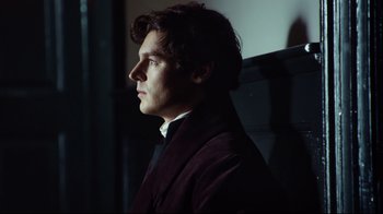Movie still from “In the Heart of the Sea” (2015), directed by Ron Howard – A man in a suit looking to his left; Close Up shot, Low angle