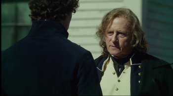 Movie still from “In the Heart of the Sea” (2015), directed by Ron Howard – A man with long wavy hair and a beard talking to another man with long wavy hair; Close Up shot, Over the shoulder angle