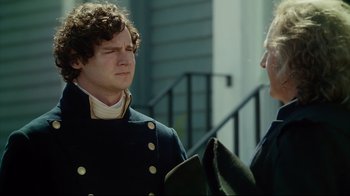 Movie still from “In the Heart of the Sea” (2015), directed by Ron Howard – Two men in military garb talking to each other outside; Close Up shot, Over the shoulder angle