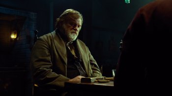Movie still from “In the Heart of the Sea” (2015), directed by Ron Howard – A man sitting at a table with a pen in his hand; Medium shot, Over the shoulder angle
