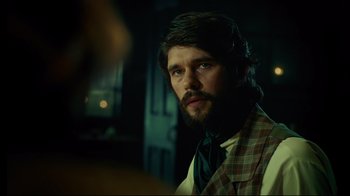 Movie still from “In the Heart of the Sea” (2015), directed by Ron Howard – A man with long hair and a beard wearing a vest and tie; Close Up shot, Over the shoulder angle