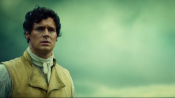 Movie still from “In the Heart of the Sea” (2015), directed by Ron Howard – A man standing in front of a cloudy sky; Close Up shot, Low angle