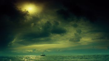 Movie still from “In the Heart of the Sea” (2015), directed by Ron Howard – A sailboat in the middle of the ocean under a cloudy sky; Extreme Wide shot, Low angle