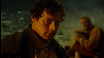 Movie still from “In the Heart of the Sea” (2015), directed by Ron Howard – A person with curly hair; Close Up shot, Over the shoulder angle