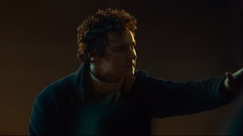 Movie still from “In the Heart of the Sea” (2015), directed by Ron Howard – A man with a curly red hair and a black jacket; Close Up shot, Over the shoulder angle