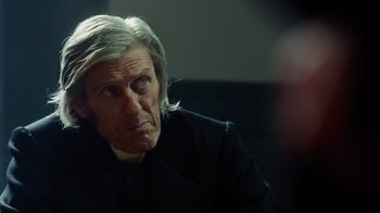 Movie still from “In the Heart of the Sea” (2015), directed by Ron Howard – An older man with long white hair looking at the camera; Close Up shot, Over the shoulder angle