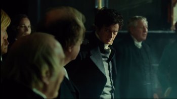Movie still from “In the Heart of the Sea” (2015), directed by Ron Howard – A group of men standing next to each other in a room; Medium shot, Over the shoulder angle