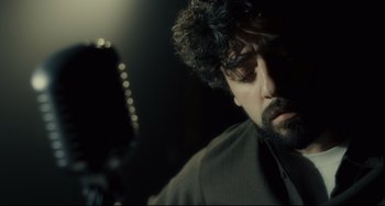 Movie still from “Inside Llewyn Davis” (2013), directed by Ethan Coen – A person with a microphone; Close Up shot, Low angle