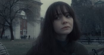 Movie still from “Inside Llewyn Davis” (2013), directed by Ethan Coen – A person with long black hair; Close Up shot, Over the shoulder angle