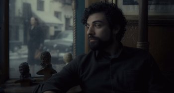 Movie still from “Inside Llewyn Davis” (2013), directed by Ethan Coen – A man sitting in a chair looking out a window; Close Up shot, Over the shoulder angle
