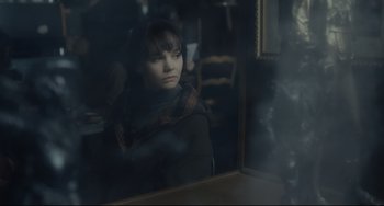 Movie still from “Inside Llewyn Davis” (2013), directed by Ethan Coen – A woman sitting at a table looking out of a window; Medium shot, Over the shoulder angle