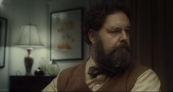 Movie still from “Inside Llewyn Davis” (2013), directed by Ethan Coen – A man with a long beard and a bow tie; Close Up shot, Over the shoulder angle