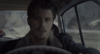 Movie still from “Inside Llewyn Davis” (2013), directed by Ethan Coen – A man sitting in the drivers seat of a car; Close Up shot, Over the shoulder angle