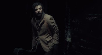 Movie still from “Inside Llewyn Davis” (2013), directed by Ethan Coen – A man with a beard wearing a brown jacket; Medium shot, Over the shoulder angle