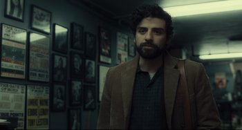 Movie still from “Inside Llewyn Davis” (2013), directed by Ethan Coen – A man with a beard wearing a brown jacket; Medium shot, Over the shoulder angle